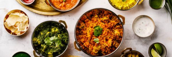 Indian food Curry butter chicken, Palak Paneer, Chiken Tikka, Biryani, Papad, Dal, Rice with Saffron and Naan bread on white background