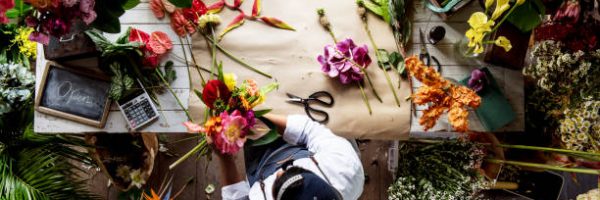 Florist working on flower arrangement among the flower