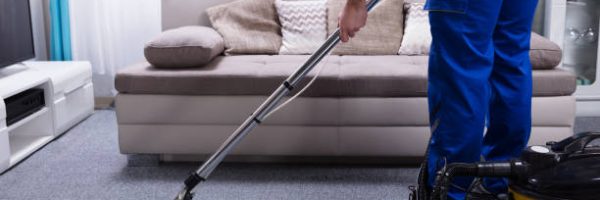 Janitor's Hand Cleaning Carpet With Vacuum Cleaner