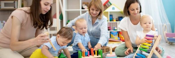 mothers-their-babies-play-developmental-toys-daycare-centre-157462840