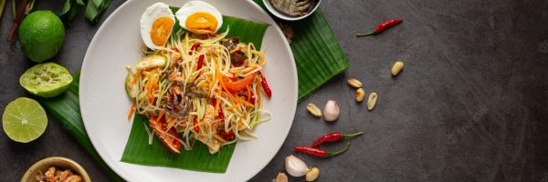 papaya-salad-served-with-rice-noodles-vegetable-salad-decorated-with-thai-food-ingredients_1150-26501