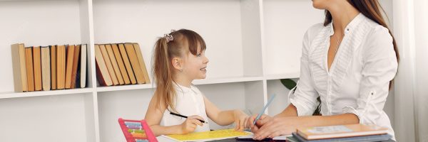 tutor-with-litthe-girl-studying-home_1157-33940